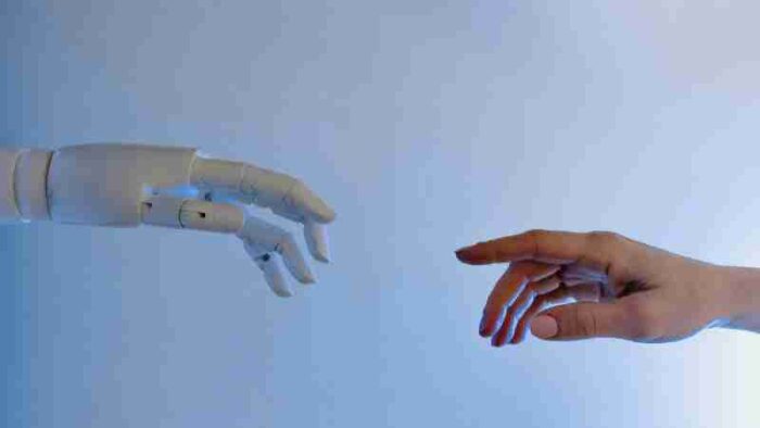 A human hand reaching towards a robotic hand symbolizing technology and connection., tags: den - pexel